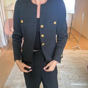 Chanel dark navy women’s military jacket with gold buttons.